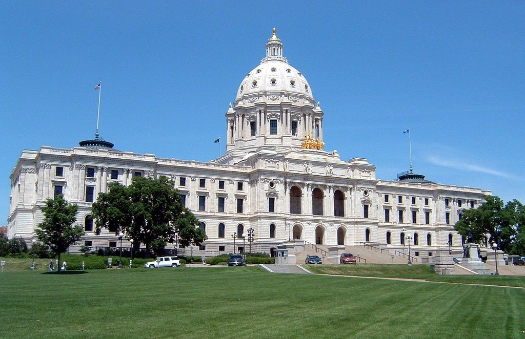 The Minnesota State Capitol in Saint Paul, a white marble dome above a green lawn